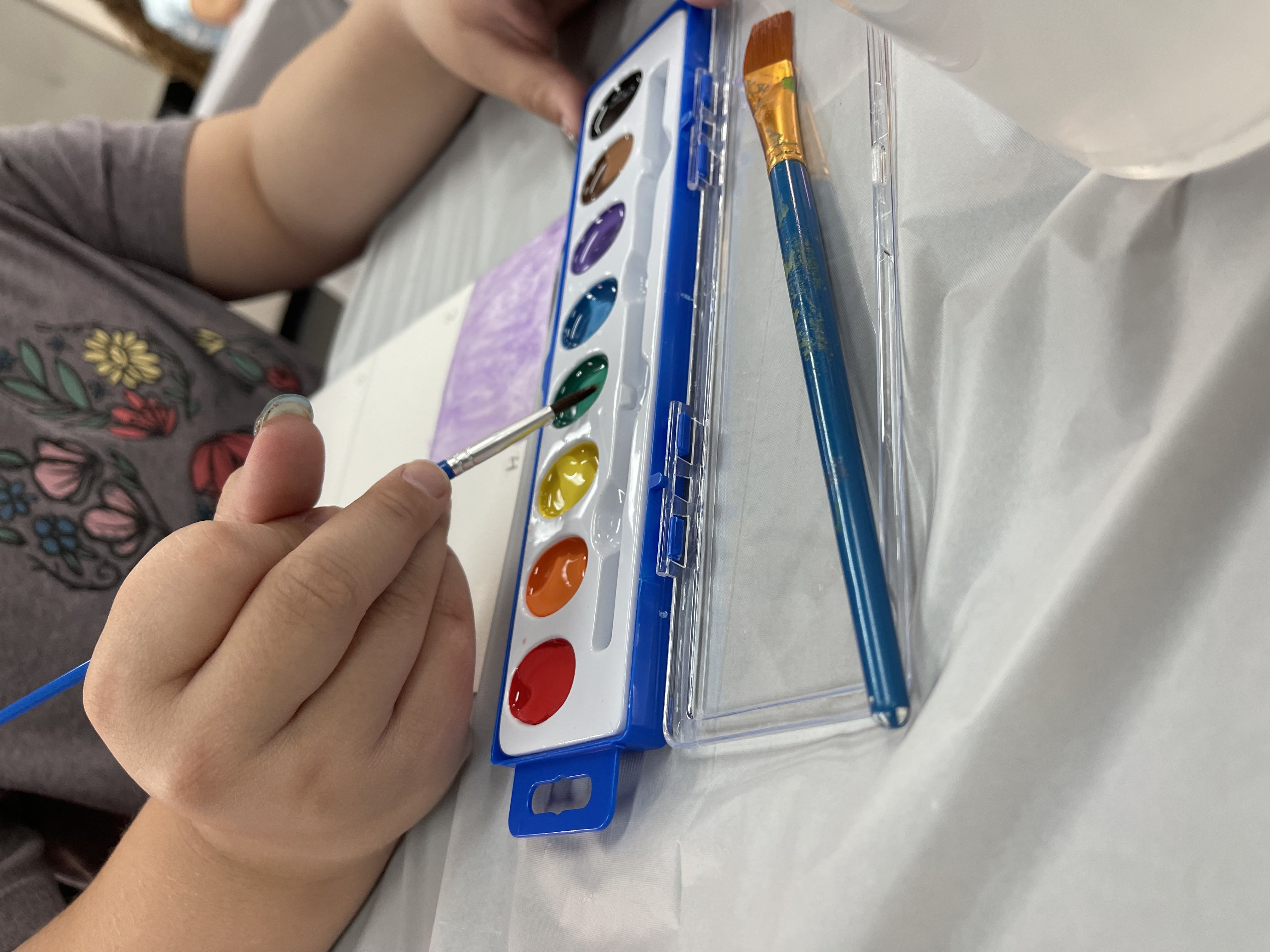 Child sketching or practicing an art technique