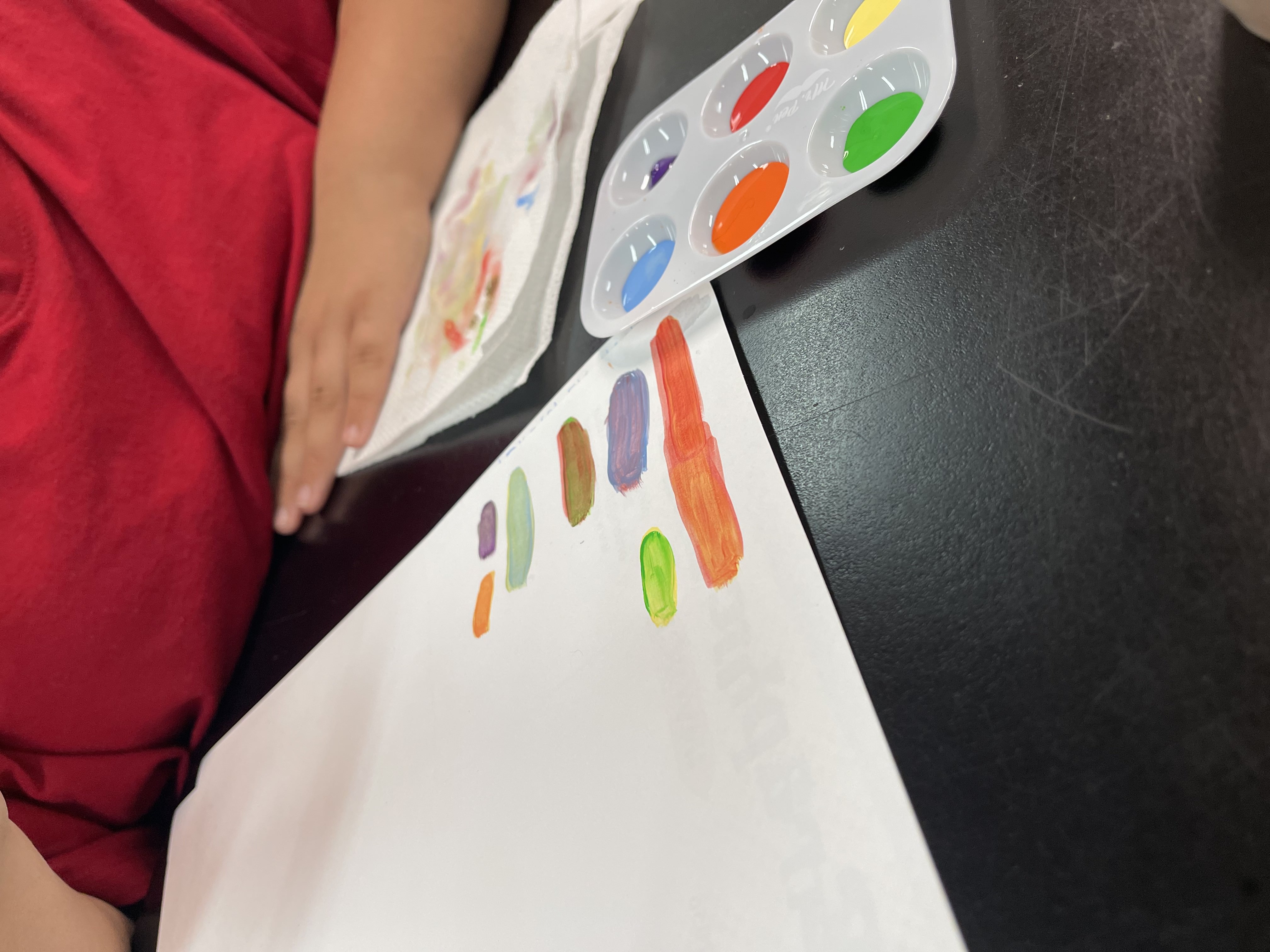 Colorful student artwork and art supplies